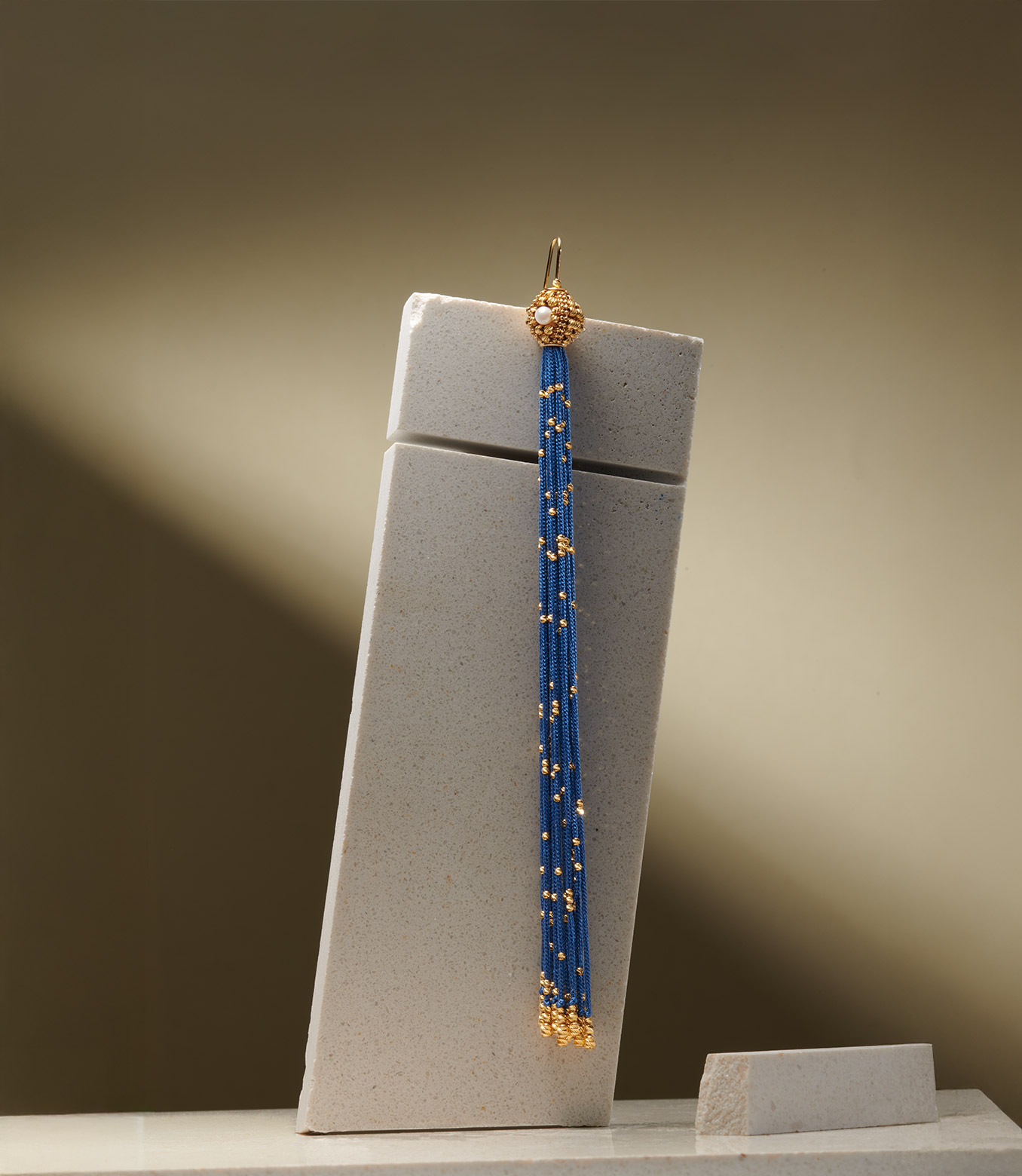 <p>Orecchino in oro giallo e seta blu con perle</p>